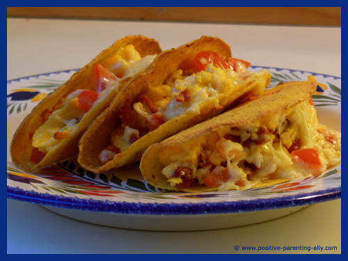 Beautiful brainy breakfast tacos with eggs, tomatos, cheese and chorizo. 