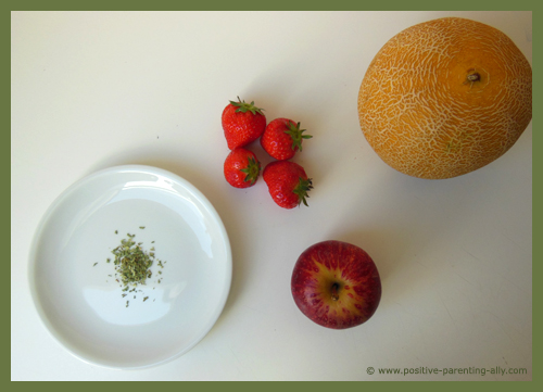 Fruit soup ingredients with strawberry, melon, apple and estragon.