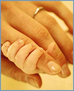 Baby hand holding mother's finger. 